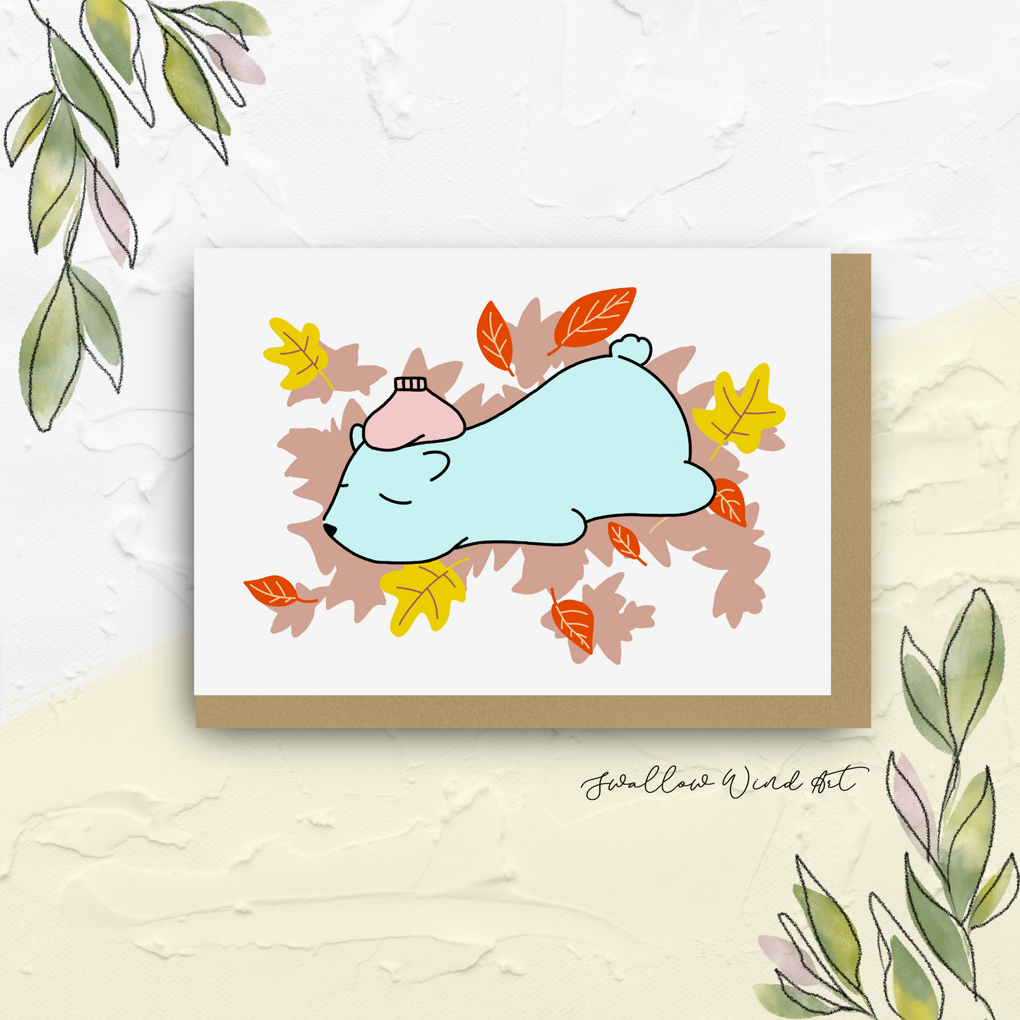 Greeting card with illustration of polar bear lying tummy down with ice pack over it's forehead surrounded by autumn leaves
